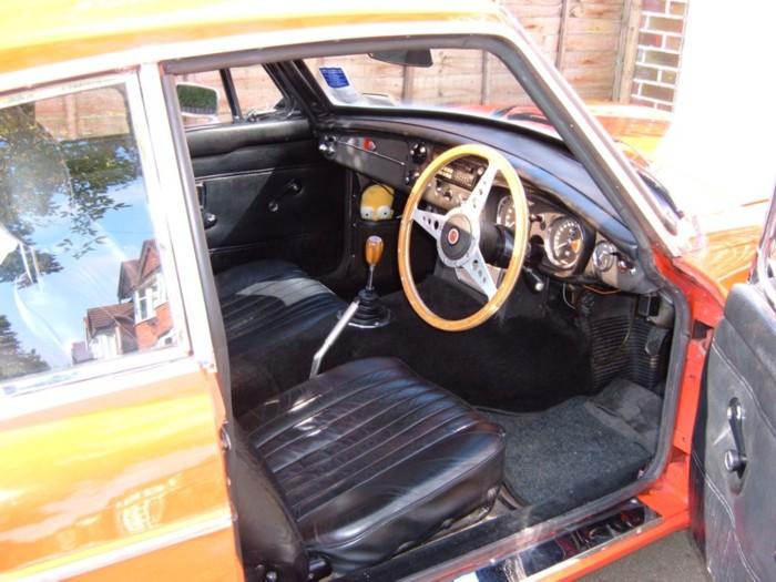 My 1970 MGB GT. Leather seats, a wooden steering wheel and gearknob, but otherwise fairly standard. Don&#039;t mind Homer, he&#039;s good for clearing the windscreen when it mists up!For more pics see my website, which is linked from the links page.