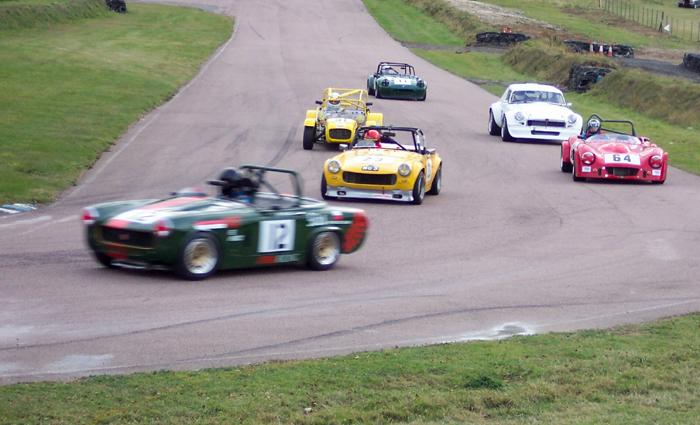 Paul Bearnal Ryan (yellow car) of the Vintage and Sportscar Garage, Harrietsham winning his class in the SEMSEC Championship at Lydden last year.